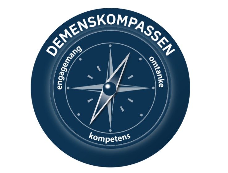 Symbolen för demenskompassen, en blå kompass med Attendos värderingsord engagemang, omtanke, kompetens